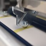 Slitter blade cutting liner. LT5C inline label rewinder and slitter for narrow label rolls