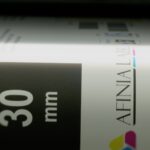 Label closeup as it exits the X350 label printer for visual inspection