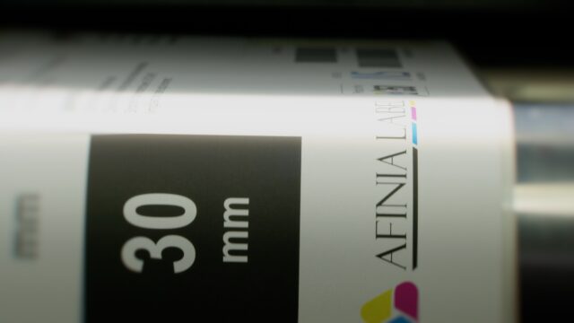 Label closeup as it exits the X350 label printer for visual inspection